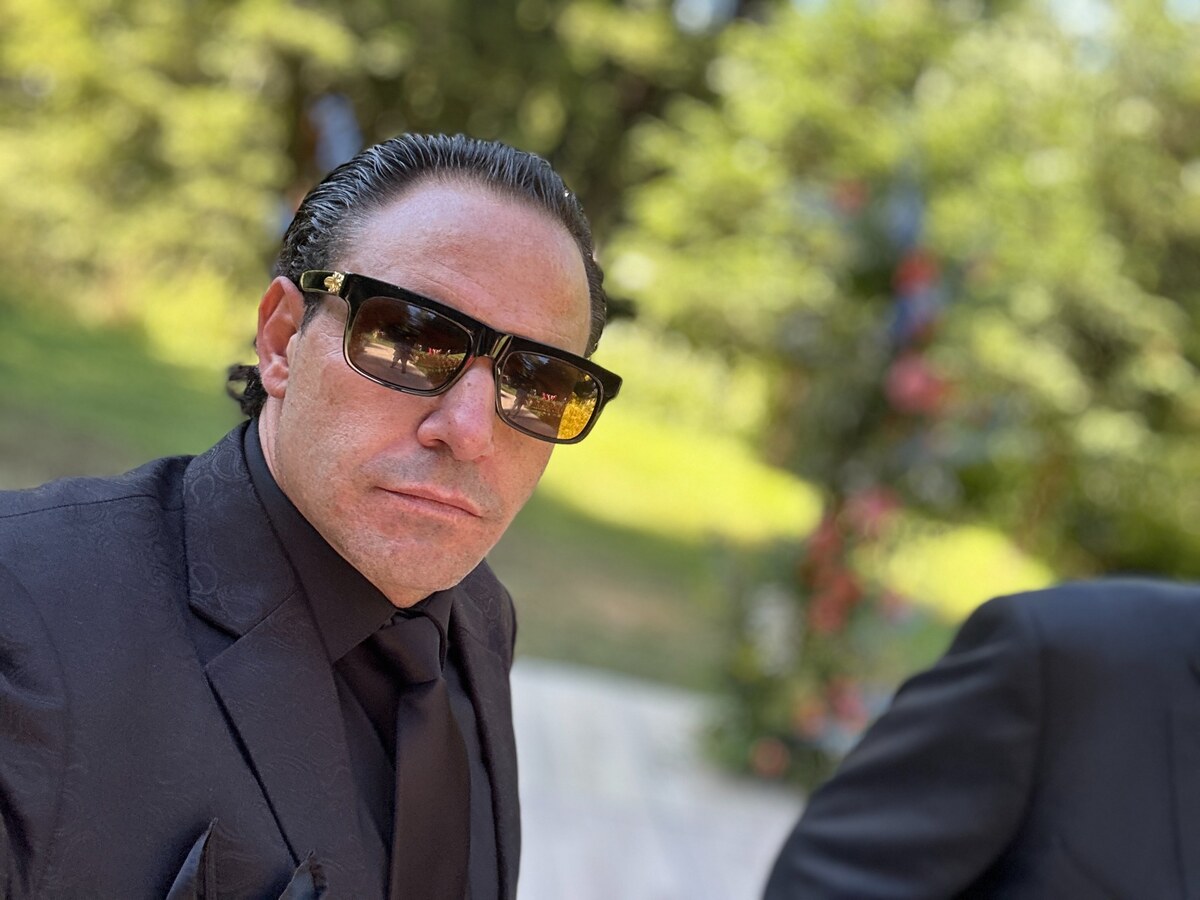 Michael Jannicelli in a black suit and sunglasses outdoors