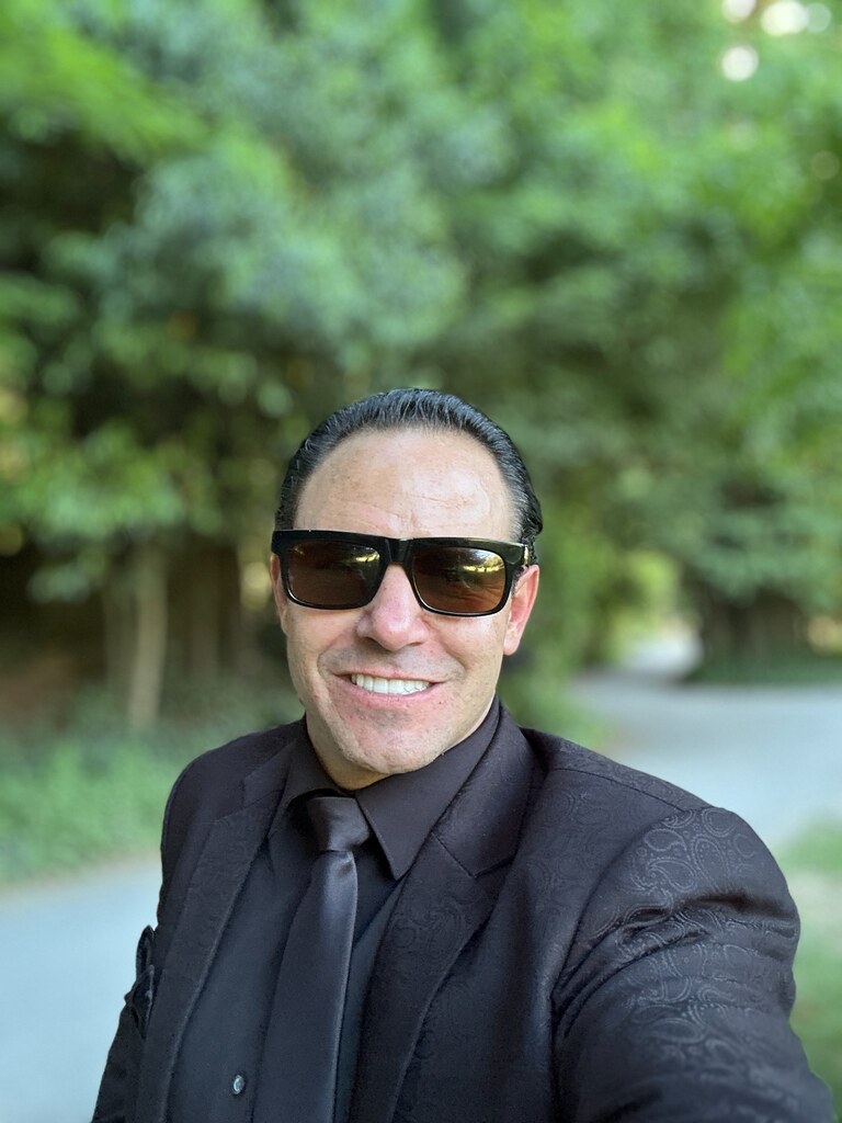 Michael Jannicelli smiling in a black suit outdoors